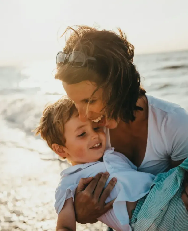 Mother and son at the beach having fun.